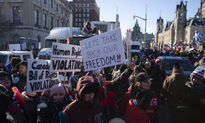 People participate in a rally against COVID-19 restrictions on Parliament Hill, a demonstration that began as a cross-country convoy protesting a federal vaccine mandate for truckers, in Ottawa on Jan. 29, 2022. (Justin Tang/The Canadian Press)