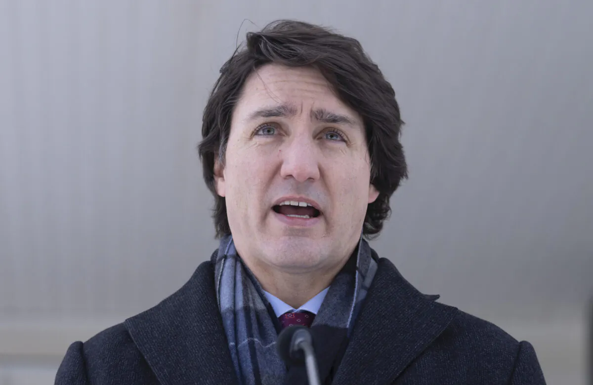 Canadian Prime Minister Justin Trudeau responds to a reporters question as he participates in a media availability held at a location in the National Capital Region which is not being made public for security reasons, on Jan. 31, 2022.  (THE CANADIAN PRESS/Adrian Wyld)