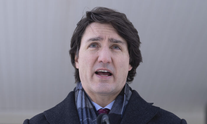 Canadian Prime Minister Justin Trudeau responds to a reporters question as he participates in a media availability held at a location in the National Capital Region which is not being made public for security reasons, on Jan. 31, 2022.  (THE CANADIAN PRESS/Adrian Wyld)