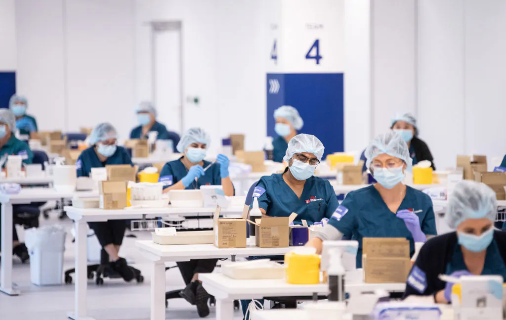 Staff prepare COVID-19 vaccines in the pharmacy area at the Olympic Park Vaccination Centre in Sydney, Australia, on May 10, 2021. (James Gourley/Pool/Getty Images)