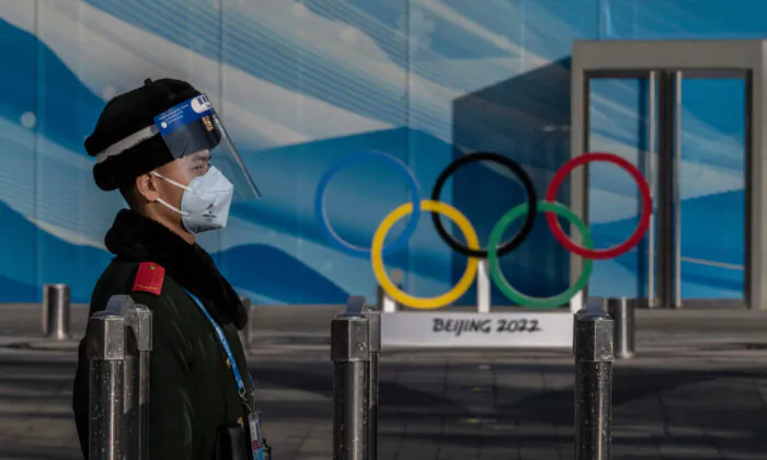 A police officer stands guard inside the closed loop bubble for the Beijing 2022 Winter Olympics near the main media center at the Olympic Park in Beijing, on Jan. 29, 2022. (Kevin Frayer/Getty Images)