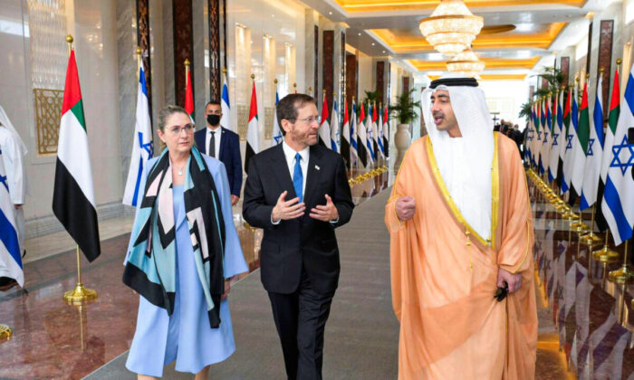 Israeli President Isaac Herzog (C) and First Lady Michal Herzog are received by UAE Foreign Minister, Sheikh Abdullah bin Zayed Al Nahyan, in Abu Dhabi, United Arab Emirates, on Jan. 30, 2022. (Amos Ben Gershom/GPO via AP)