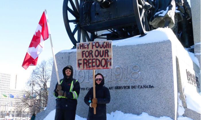 Protesters stand in front of the War Memorial in Ottawa on Jan. 29, 2022. (Noé Chartier/The Epoch Times)