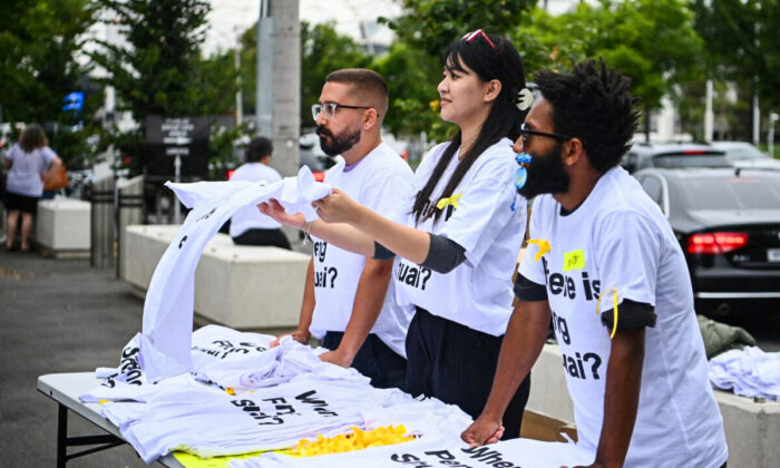 Activists hand out t-shirts reading 