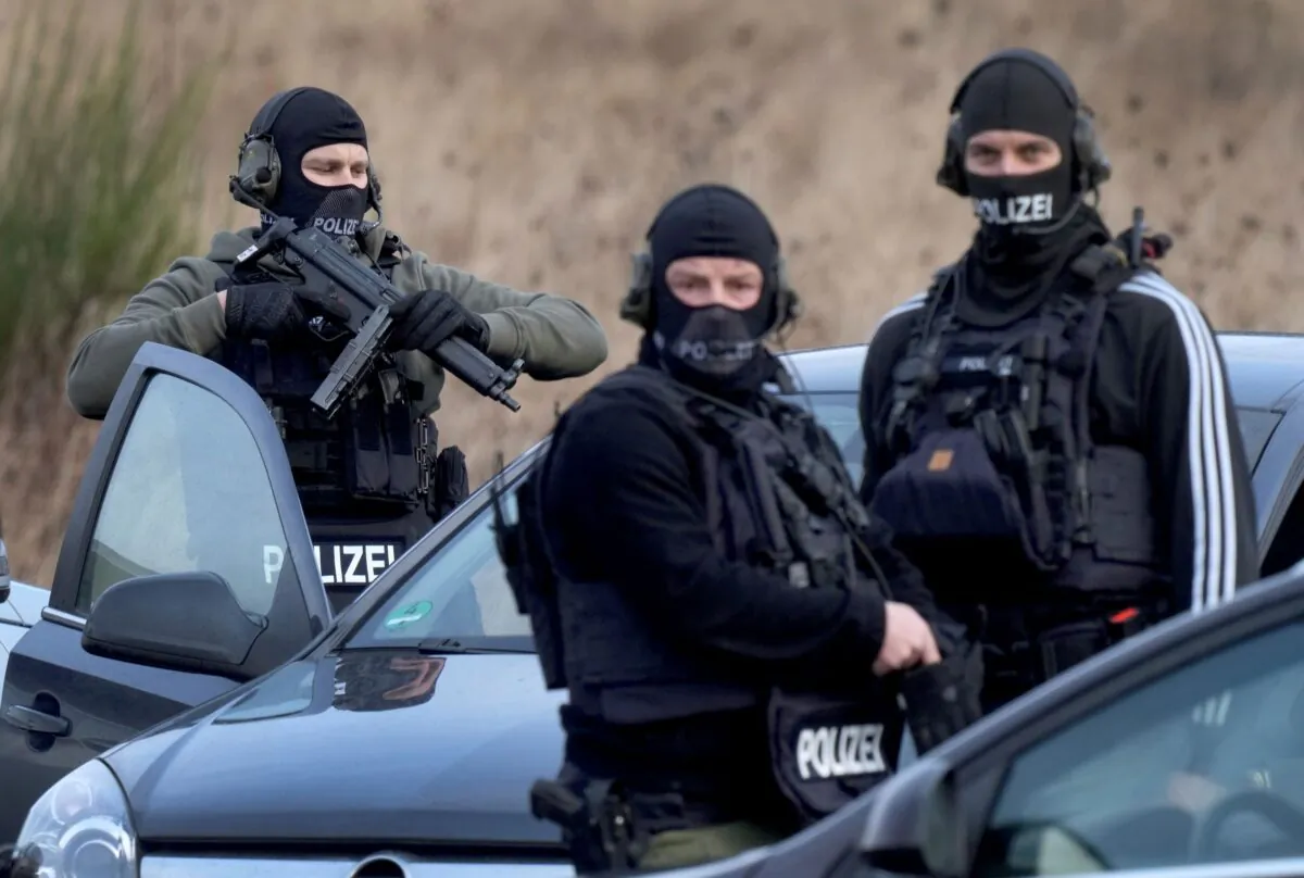 Police officers prepare for an operation close to a road where two police officers were shot during a traffic stop near Kusel, Germany, on Jan. 31, 2022. (Michael Probst/AP Photo)