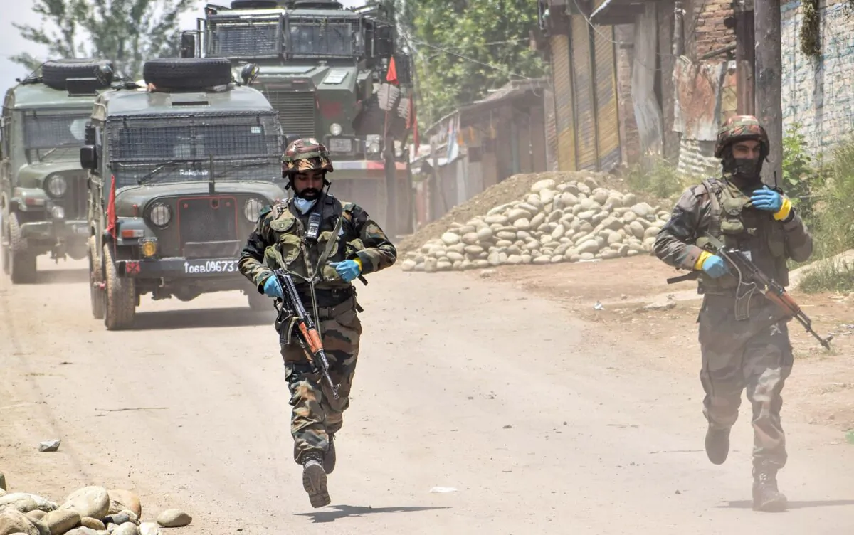 Security personnel run patrolling near the site of a gunbattle in Kangan area of south Kashmir's Pulwama district on June 3, 2020. At least three alleged Jaish-e-Mohammed terrorists were killed during a gunbattle with security personnel on June 3 at Kangan village of Pulwana district, local media reported. (STR/AFP via Getty Images)