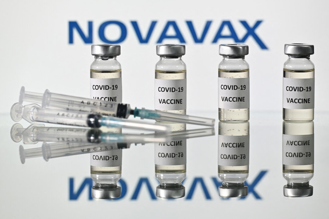 An illustration picture shows vials with COVID-19 Vaccine stickers attached and syringes with the logo of U.S. biotech company Novavax, on Nov. 17, 2020. (Justin Tallis/AFP via Getty Images)