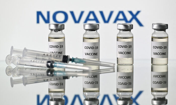 An illustration picture shows vials with COVID-19 Vaccine stickers attached and syringes with the logo of U.S. biotech company Novavax, on Nov. 17, 2020. (Justin Tallis/AFP via Getty Images)