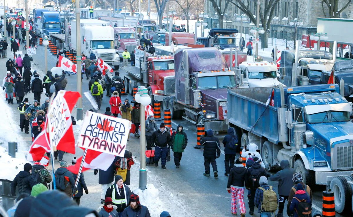 Trucks sit parked on Wellington Street near the Parliament Buildings as truckers and their supporters take part in a convoy to protest COVID-19 vaccine mandates for cross-border truck drivers in Ottawa, Canada, on Jan. 29, 2022. (Patrick Doyle/Reuters)