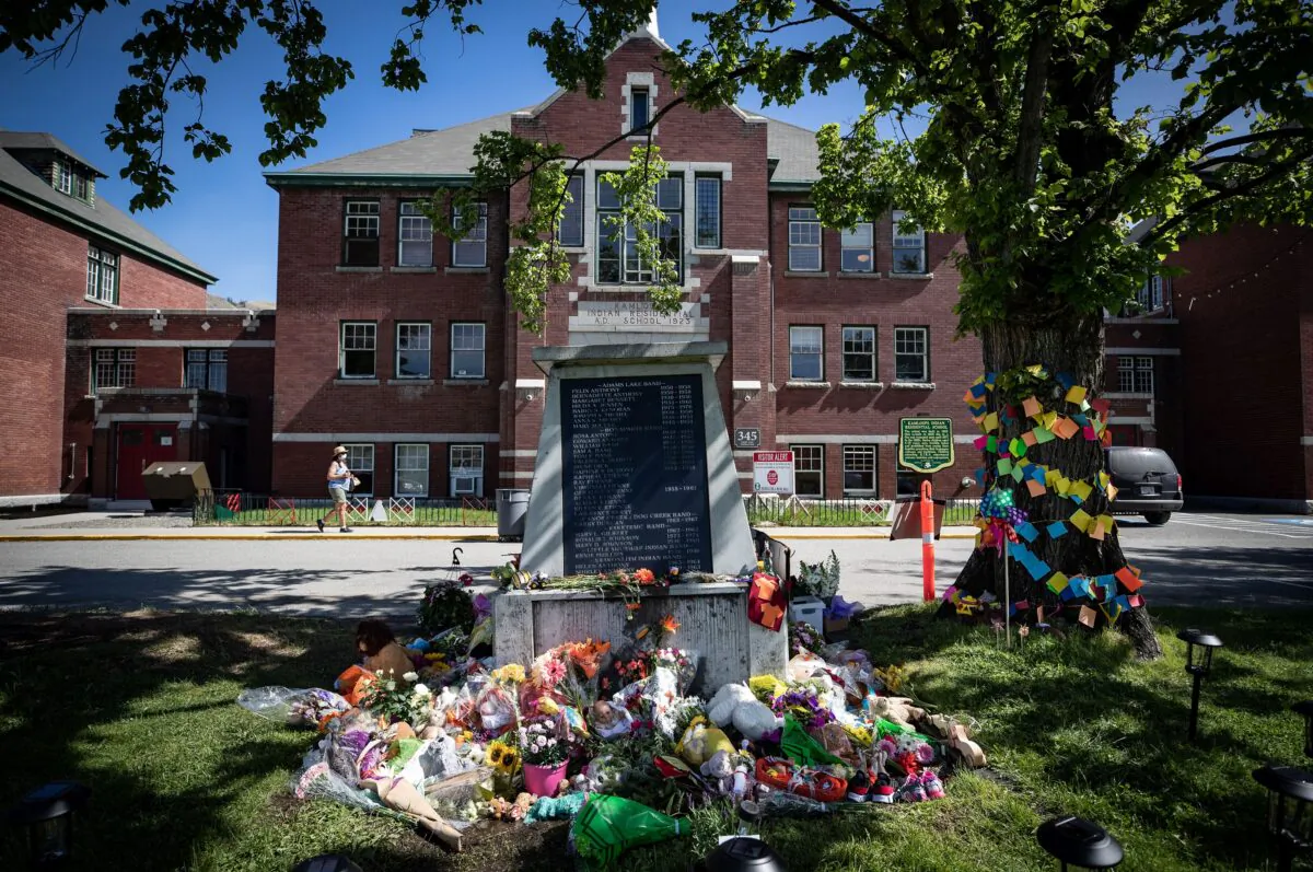 Flowers and cards are left at a monument outside the former Kamloops Indian Residential School in honour of 215 children whose potential graves were discovered near the facility, in Kamloops, B.C., on May 31, 2021. (The Canadian Press/Darryl Dyck)