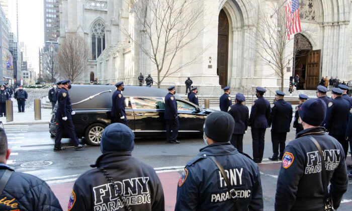 The hearse containing the casket of fallen NYPD policeman Wilbert Mora approaches St. Patrick’s Cathedral for his wake on Feb. 1, 2022. (Dave Paone/The Epoch Times)