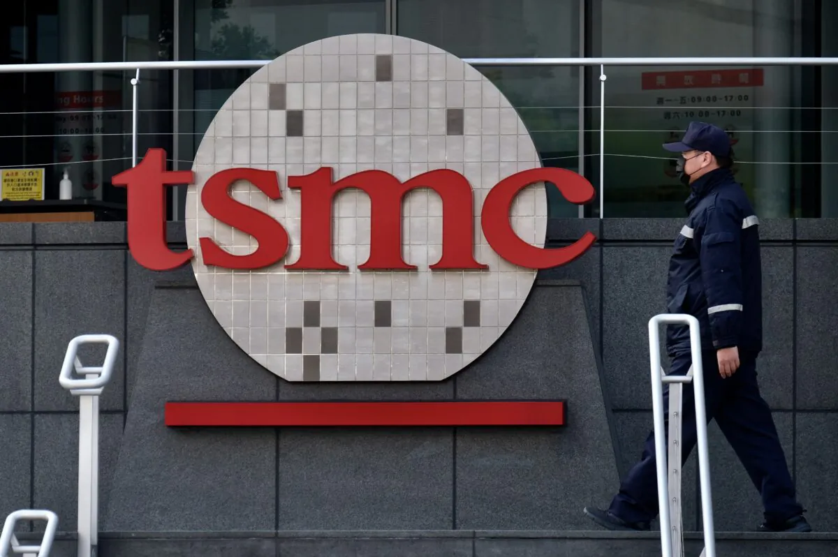 A security guard walks past a company logo at the headquarters of the world's largest semiconductor maker TSMC in Hsinchu, Taiwan, on Jan. 29, 2021. (Sam Yeh/AFP via Getty Images)