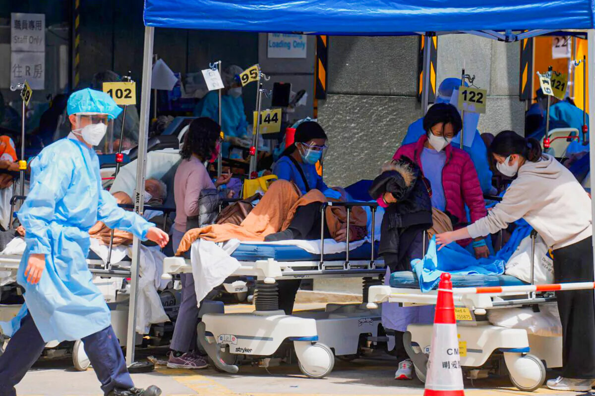 Patients in hospital beds wait at temporary holding area outside Caritas Medical Center in Hong Kong, on Feb. 28, 2022. (Vincent Yu/AP Photo)