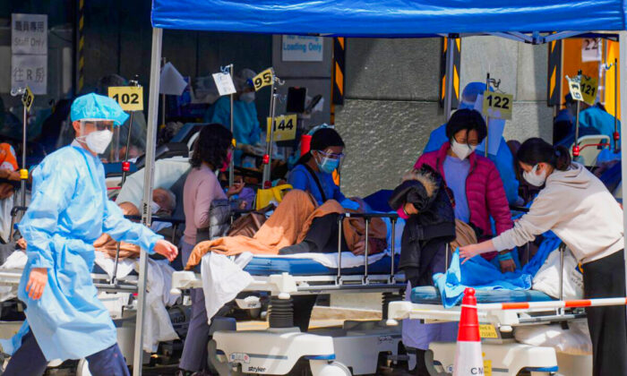 Patients in hospital beds wait at temporary holding area outside Caritas Medical Center in Hong Kong, on Feb. 28, 2022. (Vincent Yu/AP Photo)