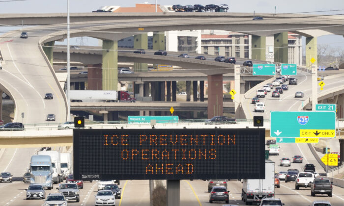 A street sign warns drivers of ice prevention operations on highways ahead of winter weather in Dallas on Feb. 1, 2022.   (LM Otero/AP Photo)