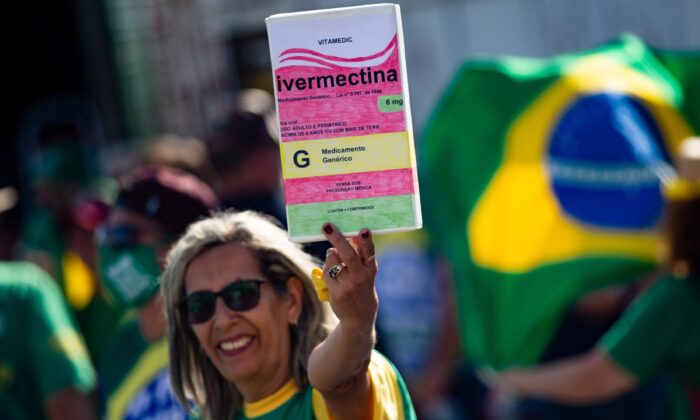 A woman holds a box of ivermectin in Brasilia, Brazil, in a file image. (Andressa Anholete/Getty Images)