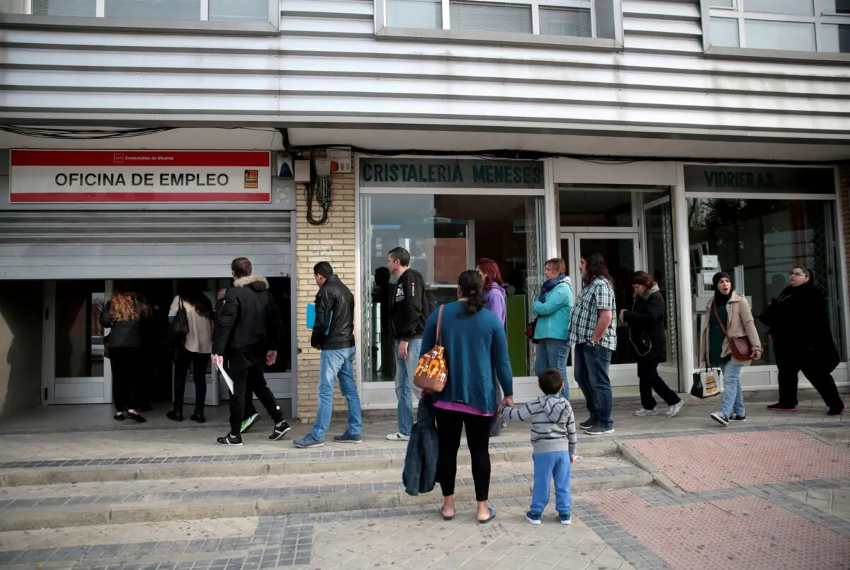 People enter a government-run job center in Madrid, Spain, on April 27, 2016. (Andrea Comas/Reuters)