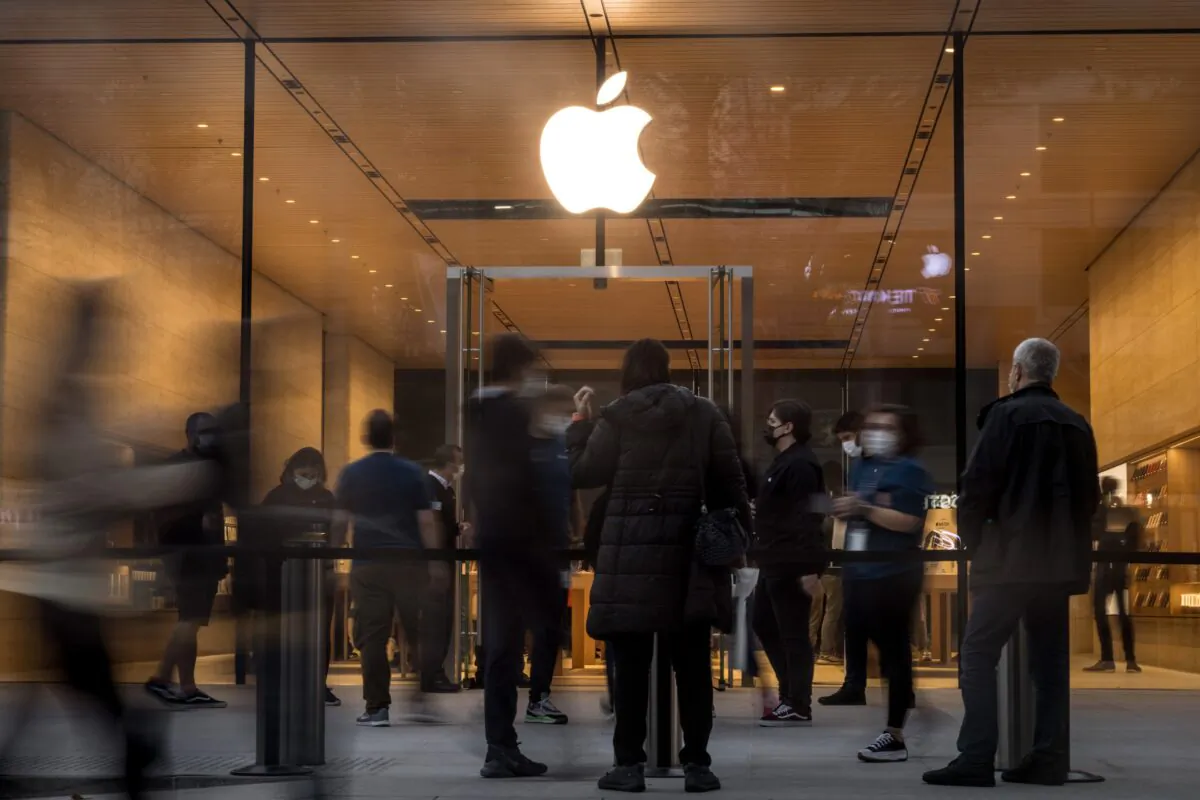 People wait outside the entrance to the new Apple retail store after its opening on Bagdat Caddesi in Istanbul, on Oct. 22, 2021. (Chris McGrath/Getty Images)