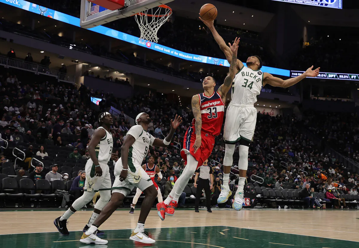 Giannis Antetokounmpo #34 of the Milwaukee Bucks blocks a shot by Kyle Kuzma #33 of the Washington Wizards during the second half of a game at Fiserv Forum, in Milwaukee, on Feb. 1, 2022. (Stacy Revere/Getty Images)