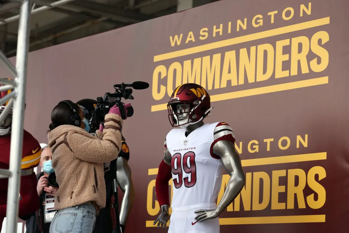 Members of the media take pictures and video of the new uniforms during the announcement of the Washington Football Team's name change to the Washington Commanders at FedExField in Landover, Md., on Feb, 2, 2022. (Rob Carr/Getty Images)