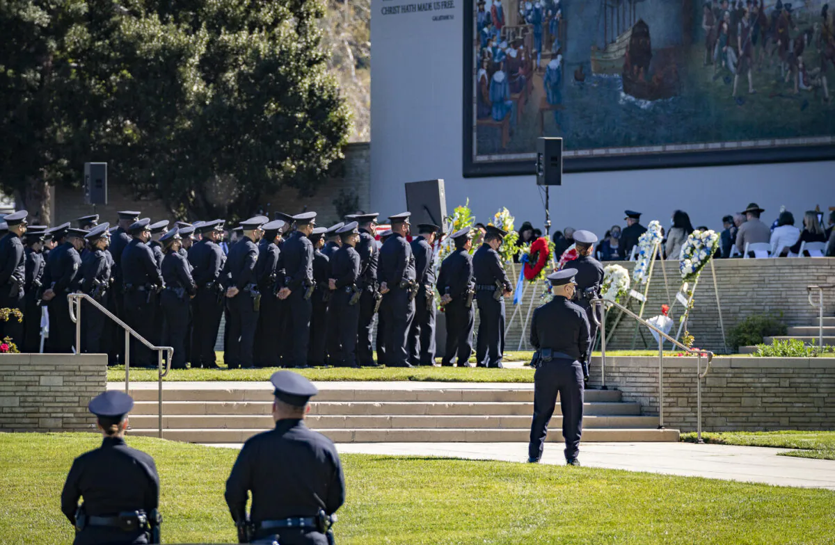 Los Angeles Police Department and Los Angeles Sheriff's Department officers pay respects at the memorial service of LAPD Officer Fernando Arroyos in Los Angeles on Feb. 2, 2022. (John Fredricks/The Epoch Times)