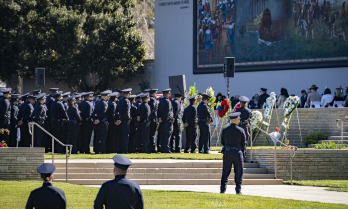 Los Angeles Police Department and Los Angeles Sheriff's Department officers pay respects at the memorial service of LAPD Officer Fernando Arroyos in Los Angeles on Feb. 2, 2022. (John Fredricks/The Epoch Times)