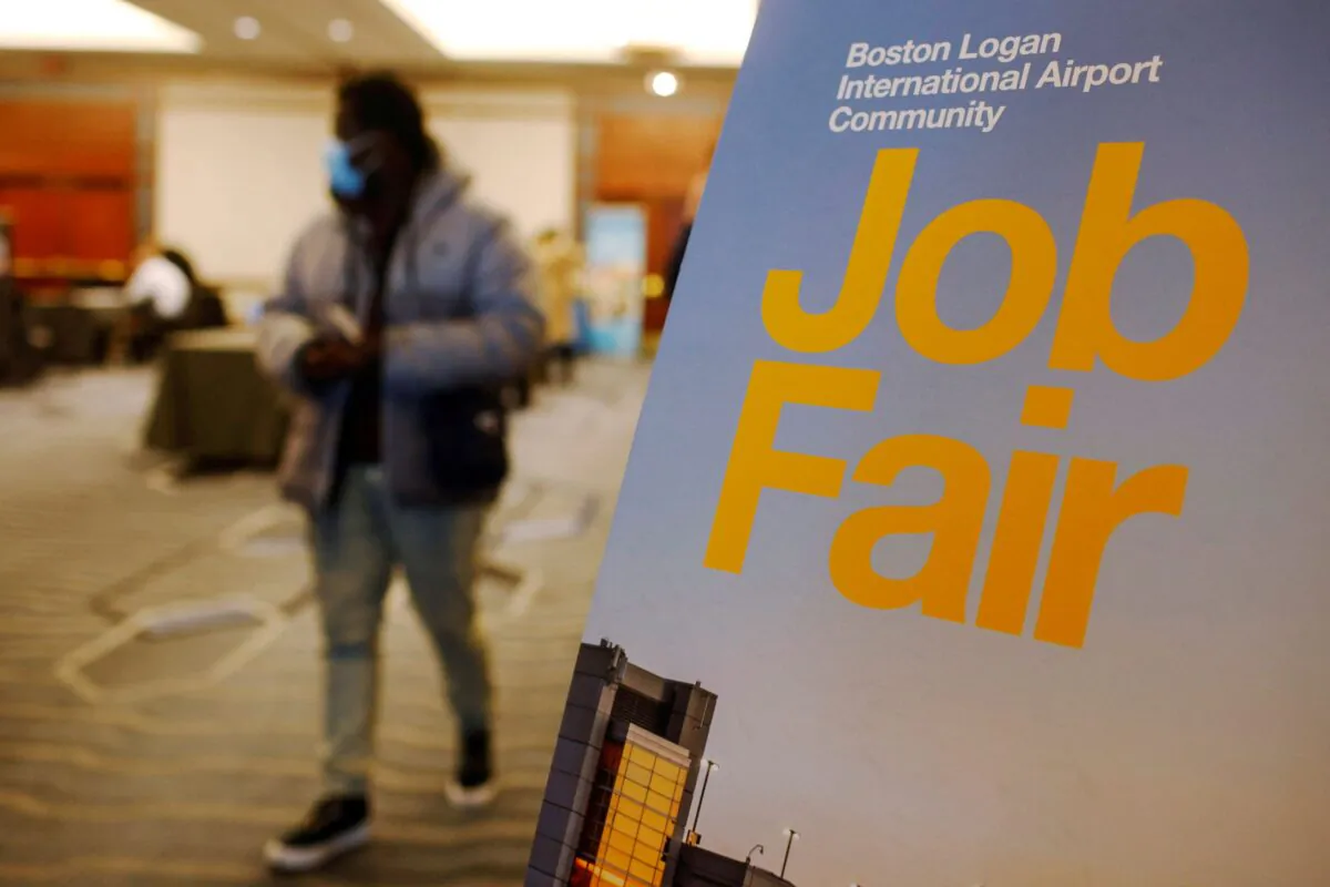 A job seeker leaves the job fair for airport related employment at Logan International Airport in Boston, Mass., on Dec. 7, 2021. (Brian Snyder/Reuters)