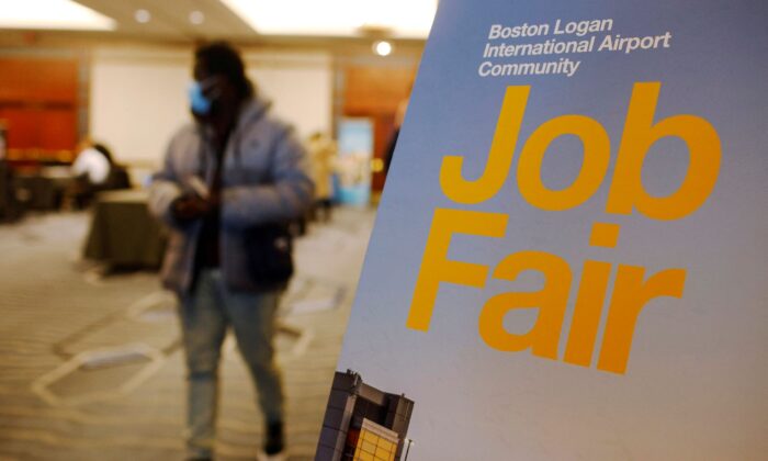 A job seeker leaves the job fair for airport related employment at Logan International Airport in Boston, Mass., on Dec. 7, 2021. (Brian Snyder/Reuters)
