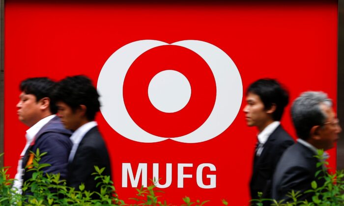People walk past a branch of Mitsubishi UFJ Financial Group's bank of Tokyo-Mitsubishi UFJ (MUFG) in Tokyo, Japan, on May 16, 2016. (Thomas Peter/Reuters)