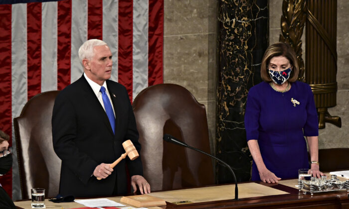 House Speaker Nancy Pelosi (D-Calif.), right, listens as Vice President Mike Pence speaks during a joint session of Congress to count the Electoral College votes of the 2020 presidential election in the House Chamber on Jan. 6, 2021. (Getty Images)