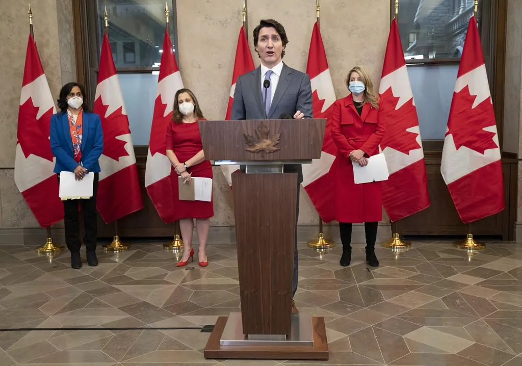 Then-Defence Minister Anita Anand, Then-Deputy Prime Minister and Finance Minister Chrystia Freeland, and Foreign Affairs Minister Melanie Joly look on as Canadian Prime Minister Justin Trudeau speaks following a cabinet retreat, Jan. 26, 2022 in Ottawa. (The Canadian Press/Adrian Wyld)