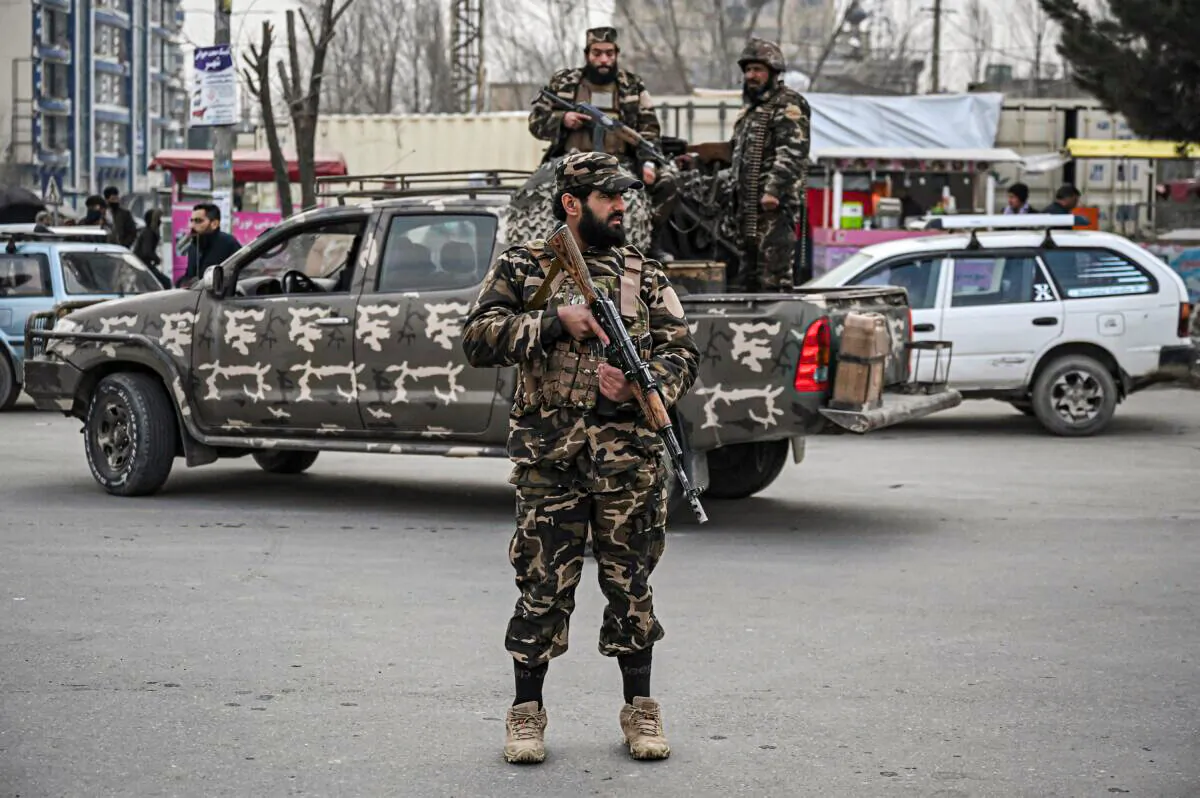 Taliban extremists stand guard along a street in Kabul on Jan. 21, 2022. (Mohd Rasfan/AFP via Getty Images)