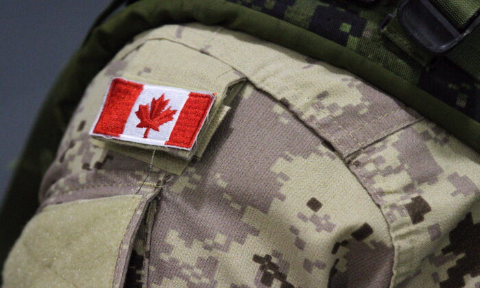 A Canadian flag patch is shown on a soldier's shoulder in Trenton, Ont., on Oct. 16, 2014. (The Canadian Press/Lars Hagberg)