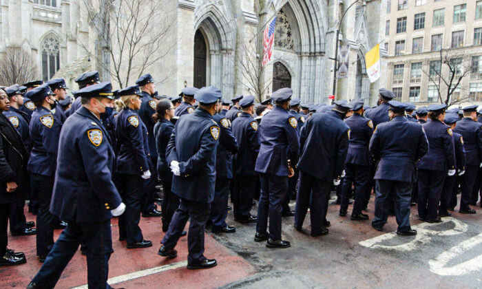 New York Police Department officers prepare to make their way into St. Patrick’s Cathedral in New York for the funeral of fallen policeman, Wilbert Mora, on Feb. 2, 2022. (Dave Paone/The Epoch Times)