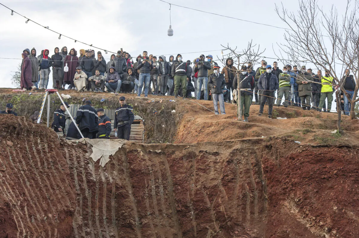 Residents watch in concern as civil defense and local authorities dig in a hill as they attempt to rescue a 5 year old boy who fell into a hole near the town of Bab Berred near Chefchaouen, Morocco on Thur. Feb. 3, 2022. (AP Photo)