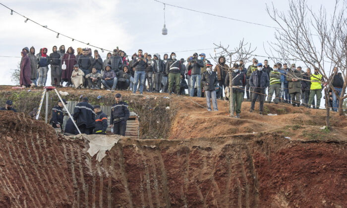 Residents watch in concern as civil defense and local authorities dig in a hill as they attempt to rescue a 5 year old boy who fell into a hole near the town of Bab Berred near Chefchaouen, Morocco on Thur. Feb. 3, 2022. (AP Photo)