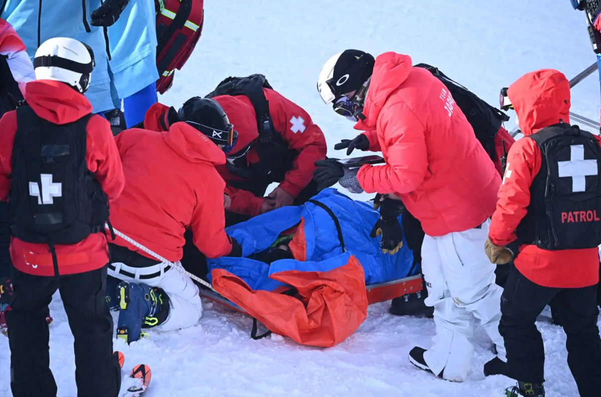 Rina Yoshika of Japan receives medical attention after falling during training in Zhangjiakou, China, on Feb. 03, 2022. (Dylan Martinez/Reuters)