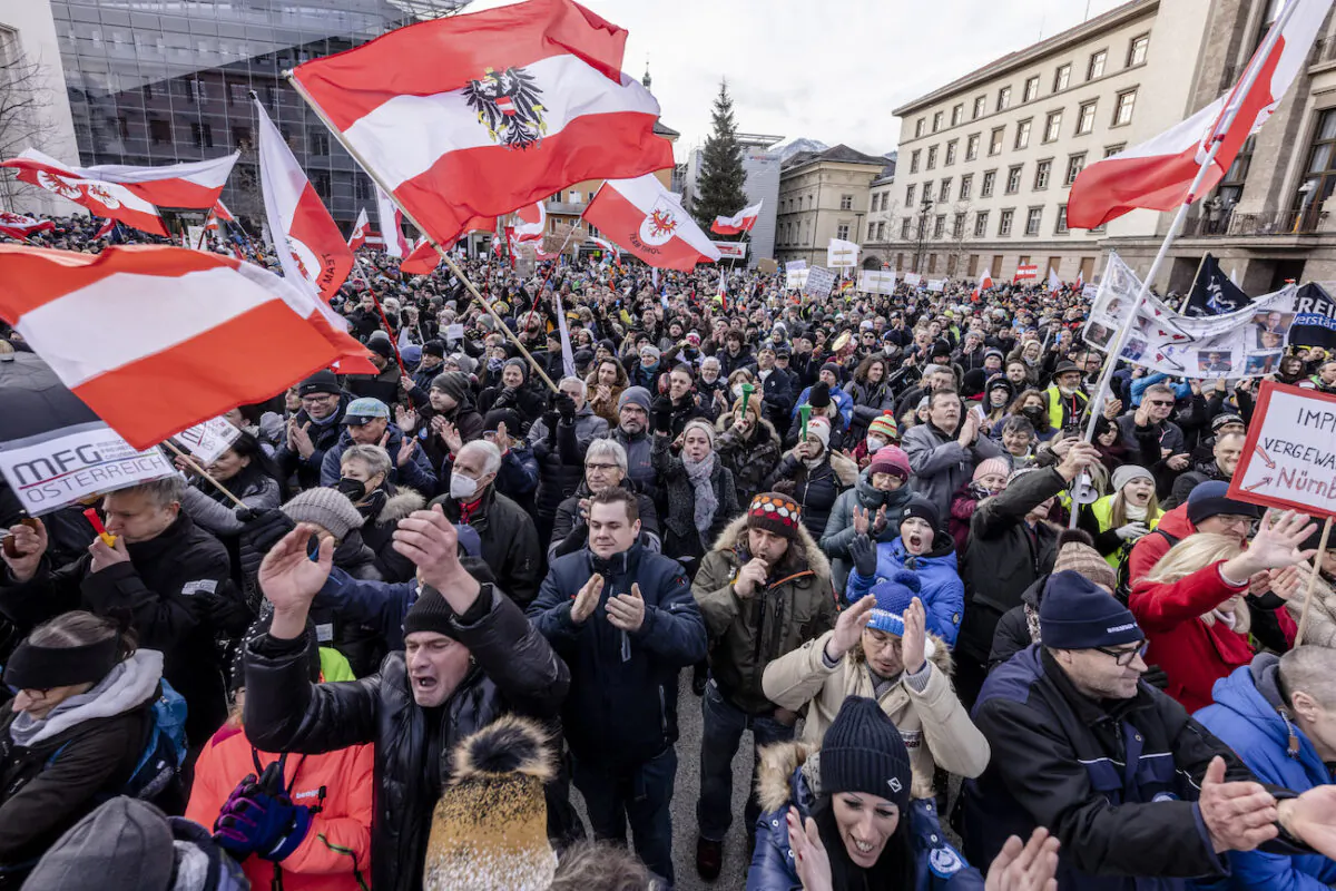 People protest at a rally, against coronavirus-related restrictions and a coming vaccination mandate in Innsbruck, Austria, on Jan. 9, 2022. (Jan Hetfleisch/Getty Images)