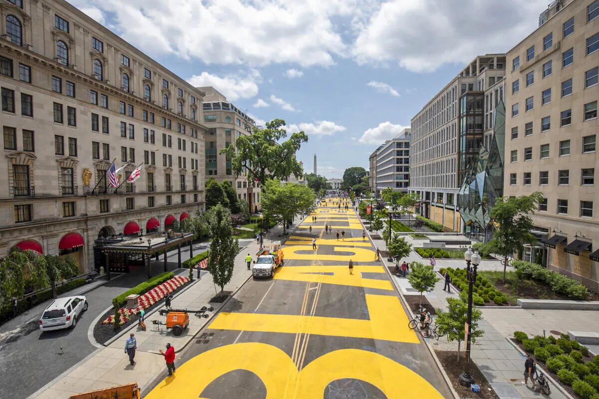 People walk down 16th street after volunteers painted "Black Lives Matter" on the street near the White House in Washington on June 5, 2020. (Tasos Katopodis/Getty Images)