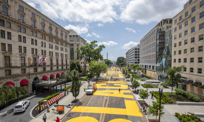 People walk down 16th street after volunteers painted "Black Lives Matter" on the street near the White House in Washington on June 5, 2020. (Tasos Katopodis/Getty Images)