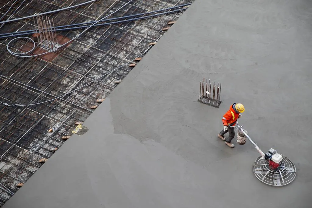 A worker smooths concrete at a construction site in Toronto, Jan. 16, 2020. (The Canadian Press/Cole Burston)
