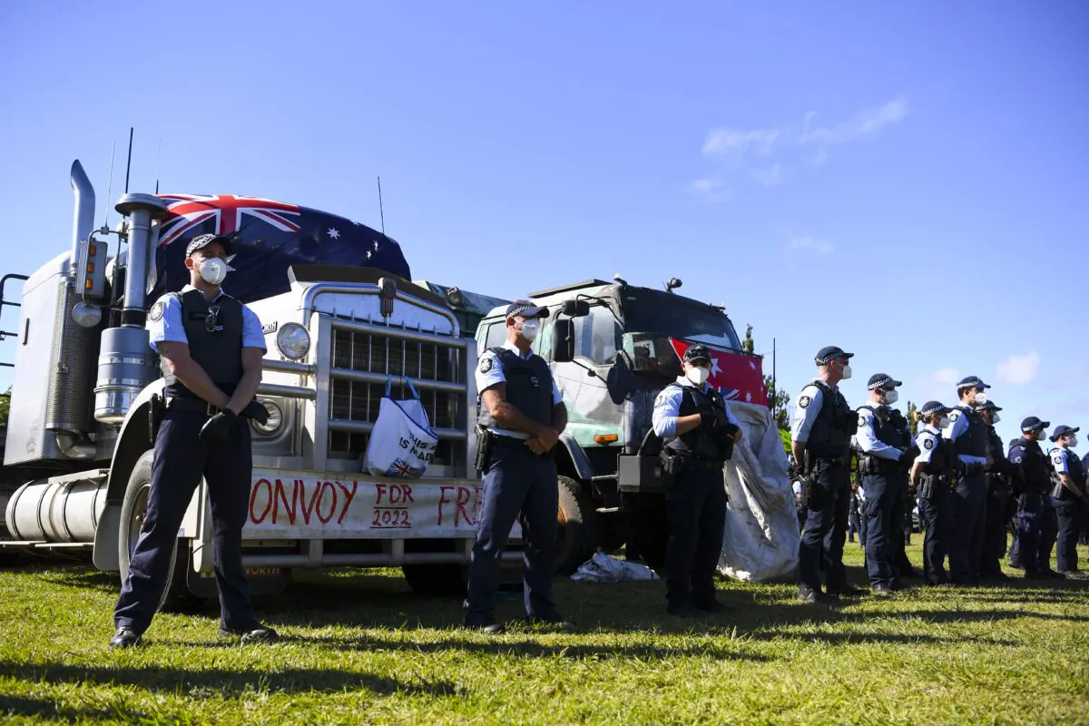 Police officers guard a truck as protesters are being moved on from makeshift camp next to the National Library in Canberra, Australia, on Feb. 4, 2022. A camp of protesters in Canberra has been given a move on order by police. (AAP Image/Lukas Coch)