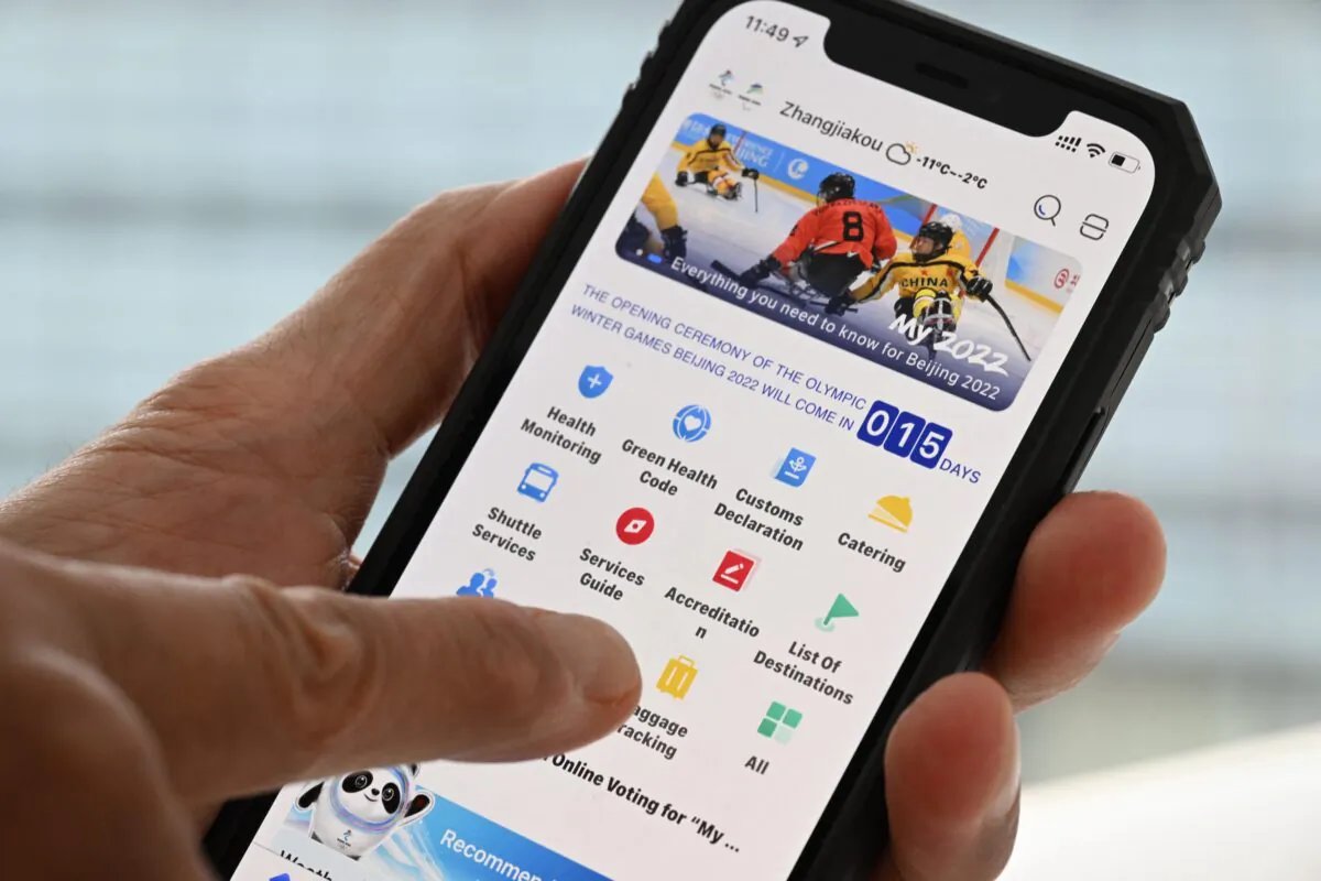 A user holds a mobile phone showing the 2022 Winter Olympic Games official app "MY 2022" in Beijing on Jan. 20, 2022. (François-Xavier Marit/AFP via Getty Images)