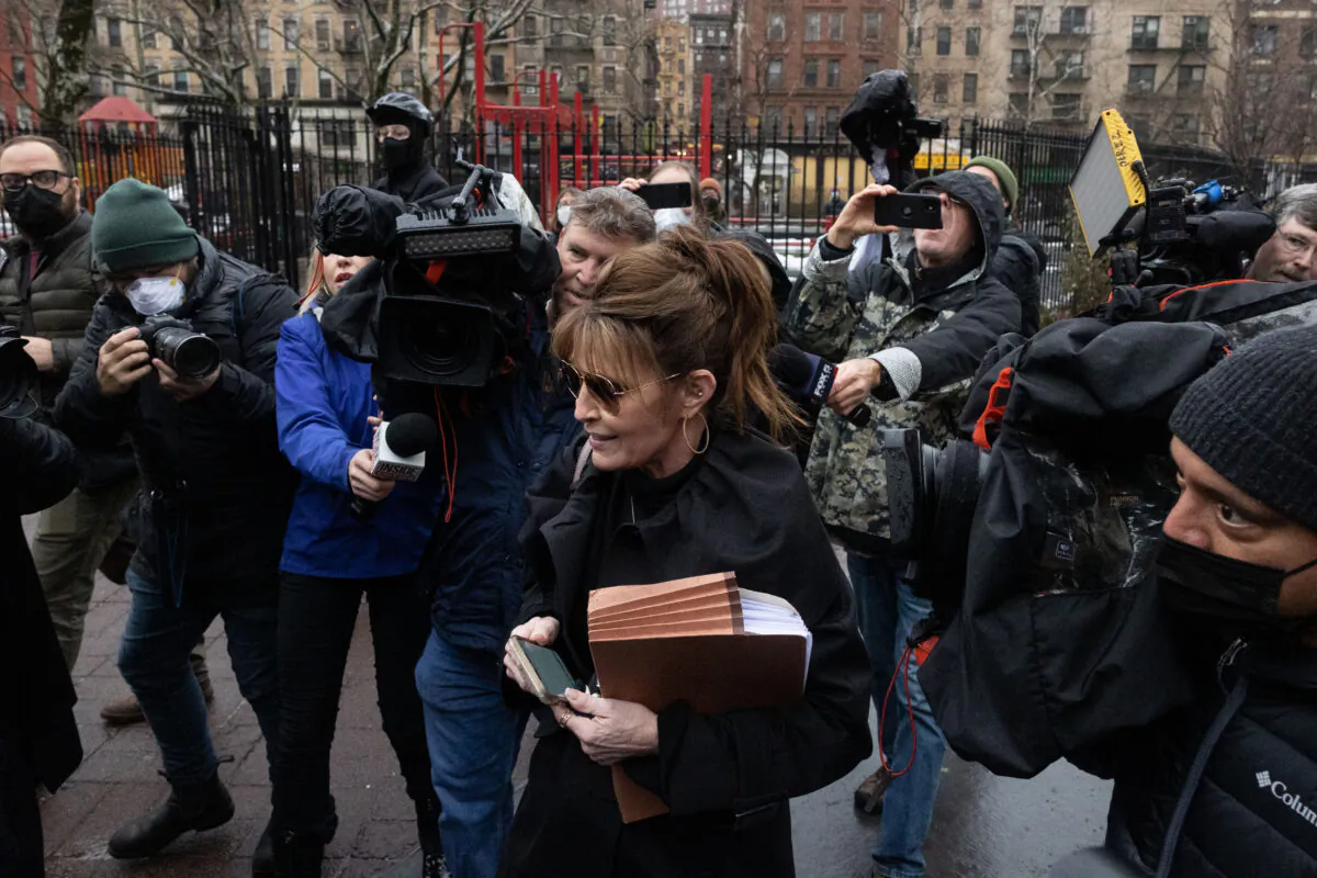 Members of the press surround former Alaska governor Sarah Palin as she leaves the federal court in New York, on February 3, 2022. (Yuki Iwamura/ AFP)