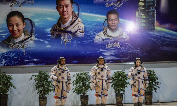 China's militant regime wants the United States to aid its space program, and some, including those in the U.S. space community, are eager to provide assistance. It seems fanciful that Chinese cooperation in space could proceed while the Communist Party maintains its goal of destroying the U.S. Pictured: The crew for China's new space station, astronauts Wang Yaping (R), Zhai Zhigang and Ye Guangfu (L), take part in a pre-launch departure ceremony at the Jiuquan Satellite Launch Center in China on Oct. 15, 2021. (Kevin Frayer/Getty Images)