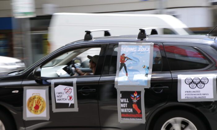 A car participating in the car parade to boycott the Beijing Olympic Games, blue poster on the car was designed by Chinese artist Badiucao, Melbourne, Australia, Feb. 4, 2022 (The Epoch Times)
