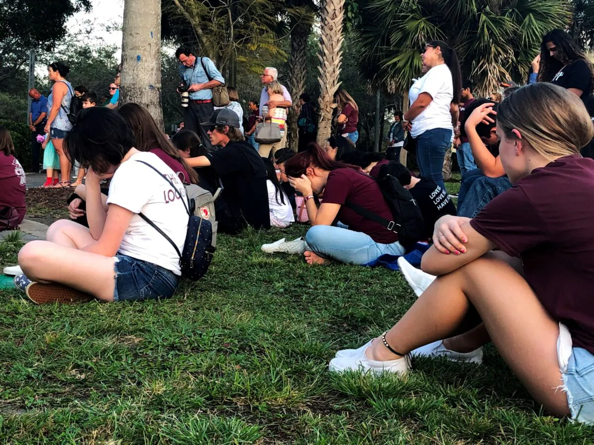 People attend a spiritual service in Pine Trails Park with leaders of several faiths in tribute of the victims of Marjory Stoneman Douglas High School shooting in Parkland, Fla., on Feb. 14, 2020. (Leila Macor/AFP via Getty Images)