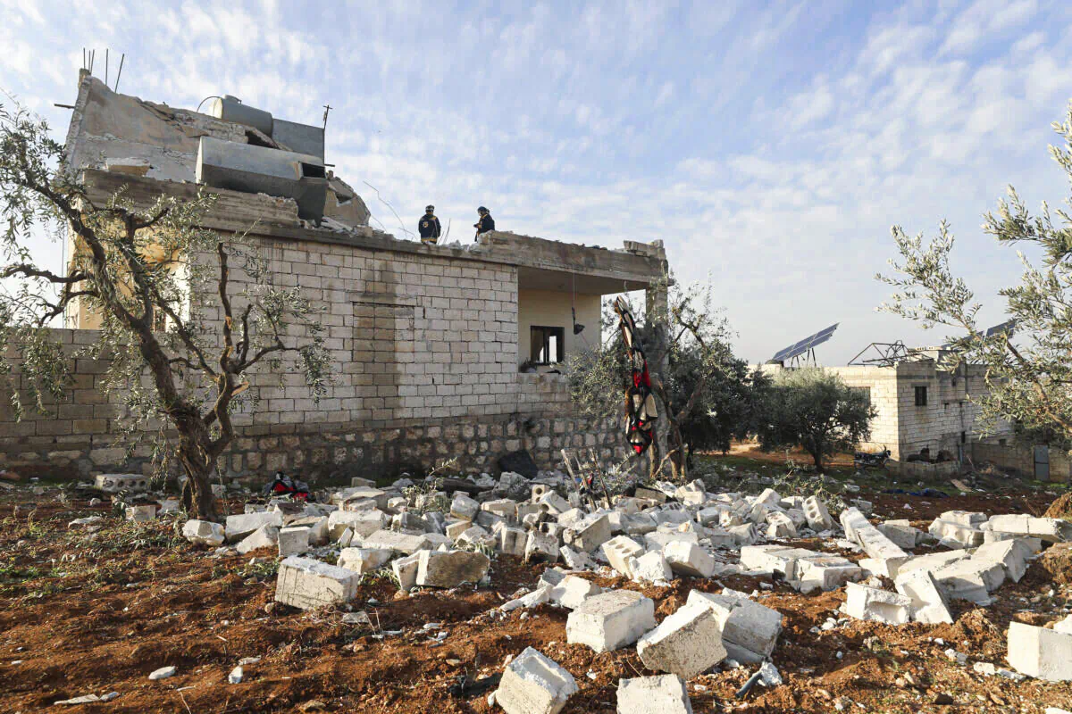 People check at a destroyed house after an operation by the U.S. military in the Syrian village of Atmeh, in Idlib province, Syria, on Feb. 3, 2022. (Ghaith Alsayed/AP Photo)