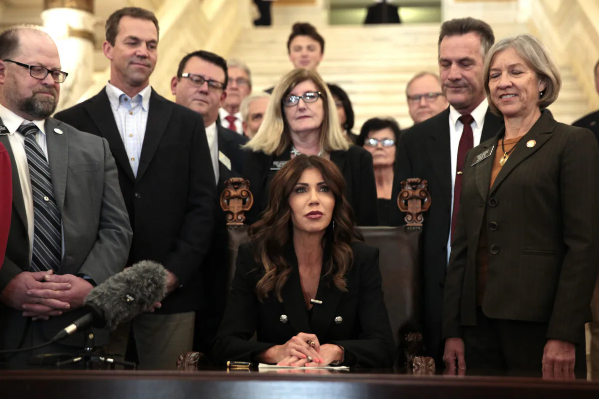 South Dakota Gov. Kristi Noem signs the "Protect Fairness in Women's Sports" bill at the state Capitol in Pierre, S.D., on Feb. 3, 2022. (Stephen Groves/AP Photo)