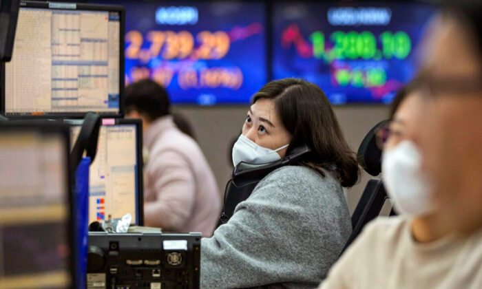 A currency trader watches monitors at the foreign exchange dealing room of the KEB Hana Bank headquarters in Seoul, South Korea, on Feb. 4, 2022. (Ahn Young-joon/AP Photo)